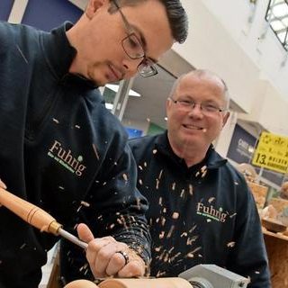 Karsten und Peter Fuhrig Zwei Handwerker drechseln, Späne fliegen umher.